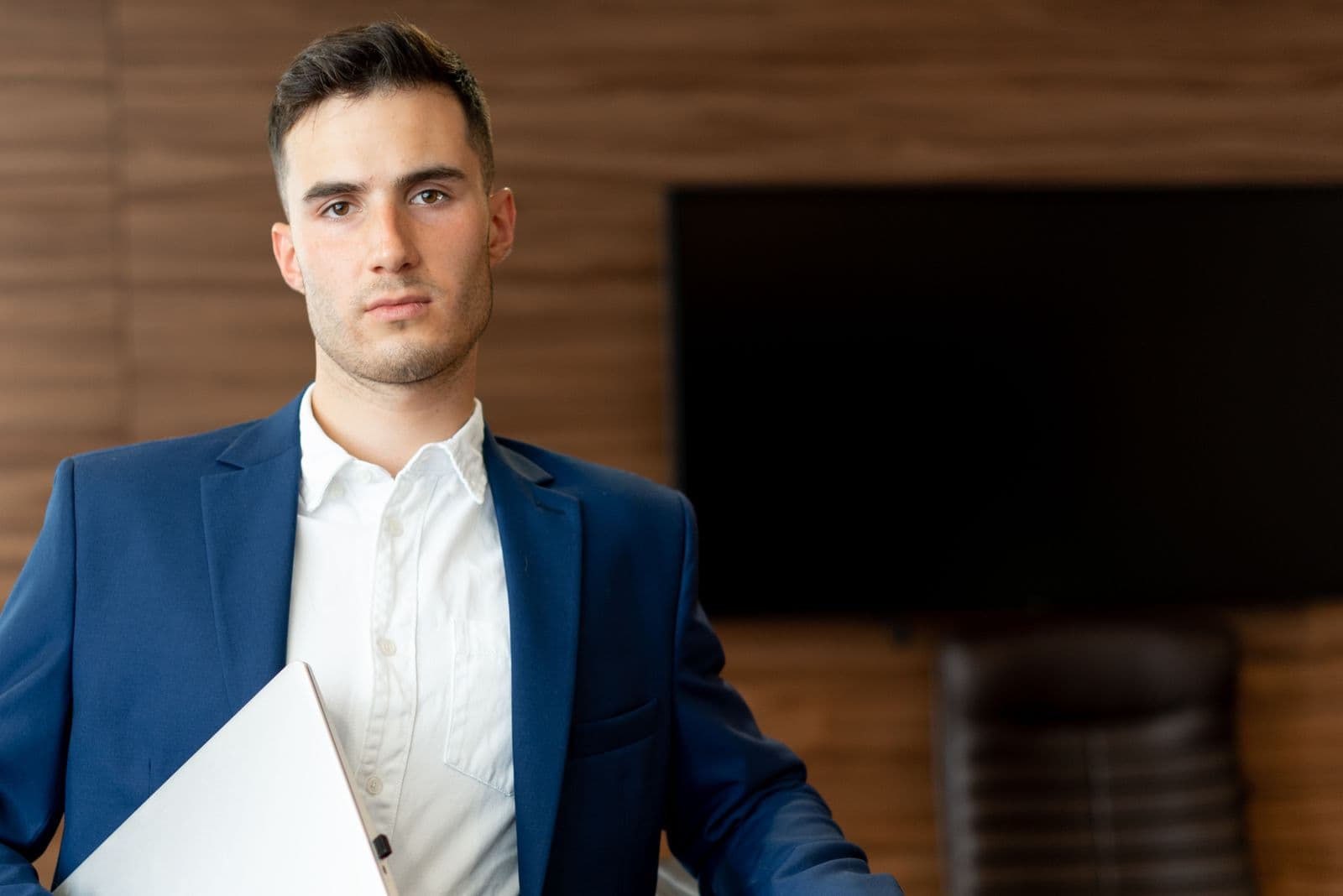 Confident businessman in a suit consulting at his office workspace