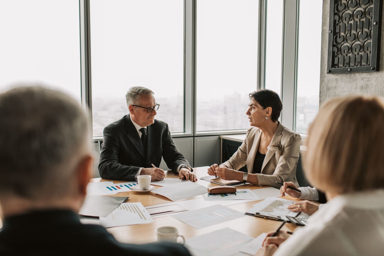 Executives gathered around the boardroom table during a corporate strategy meeting